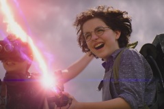 Phoebe (Mckenna Grace) and Podcast (Logan Kim, left) fire a proton pack for the first time in Columbia Pictures' GHOSTBUSTERS: AFTERLIFE.
